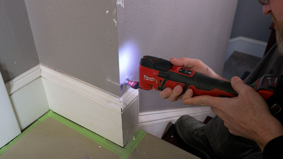 man cutting cornerbead with oscillating tool